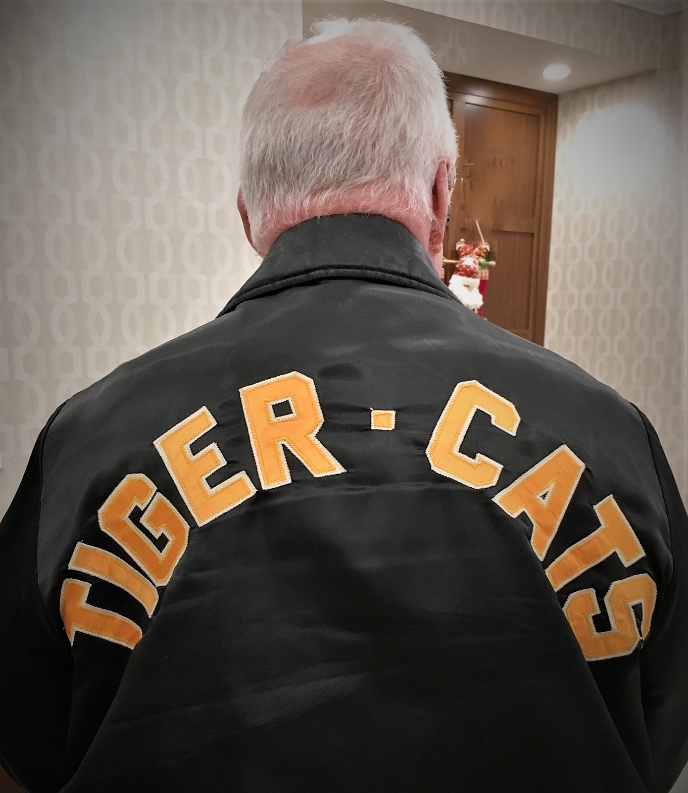 Old man wearing a tiger-cats jacket