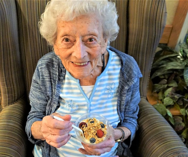 Older woman eating yogurt – All Seniors Care