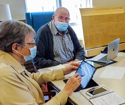 The Scoop: Blue Light and Your Eyes - All Seniors Care Senior man using a laptop and senior woman using an iPad and mobile phone.